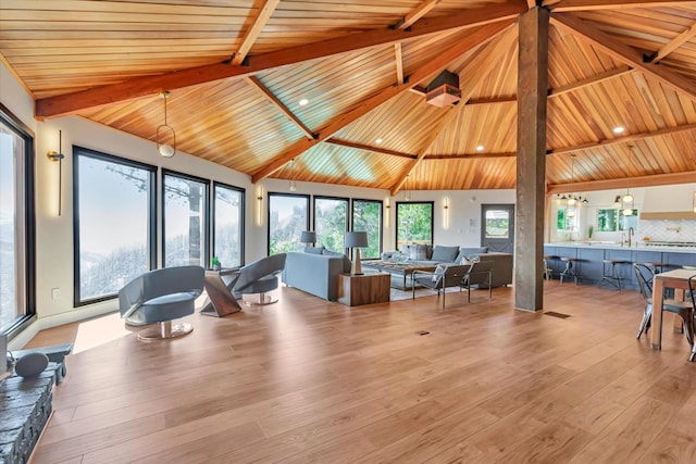 living room featuring beamed ceiling, high vaulted ceiling, wooden ceiling, and light wood-type flooring