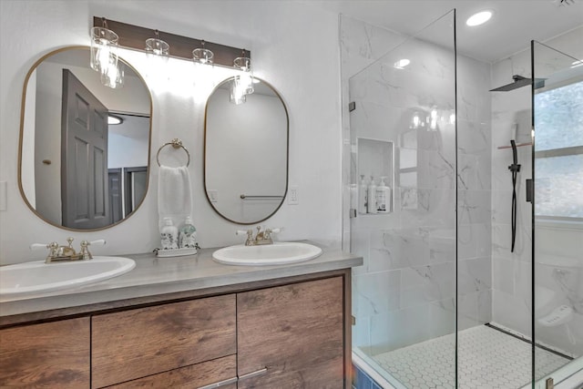 bathroom with vanity and tiled shower