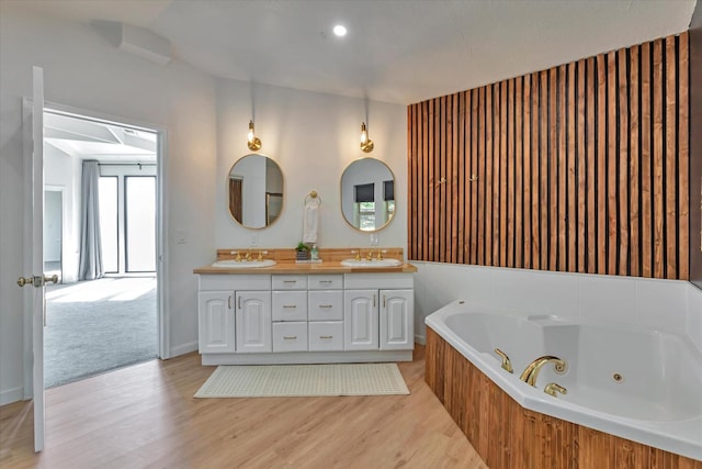 bathroom featuring hardwood / wood-style flooring, vanity, and a bathtub