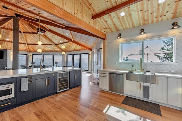 kitchen featuring beam ceiling, dishwasher, sink, wine cooler, and white cabinets