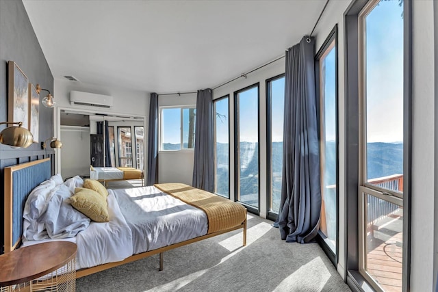 carpeted bedroom with a mountain view and a wall unit AC