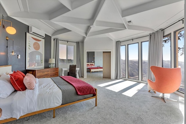 carpeted bedroom featuring a wall mounted AC and beamed ceiling