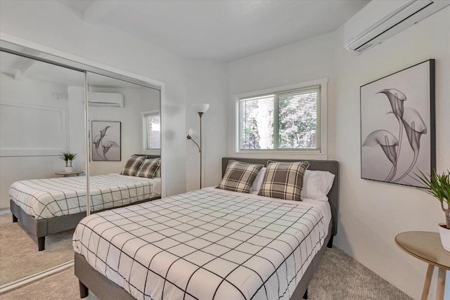 carpeted bedroom with a wall mounted AC and a closet