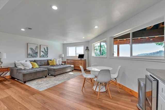 living room with light wood-type flooring and wine cooler