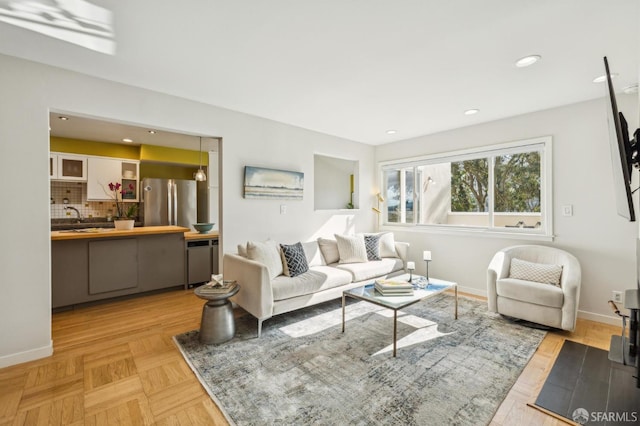 living room with light parquet flooring and sink