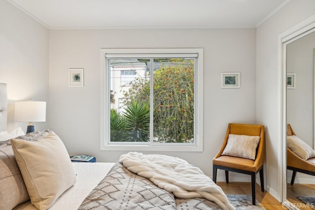 bedroom featuring hardwood / wood-style flooring and ornamental molding