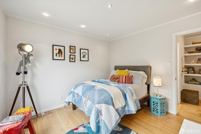 bedroom featuring wood-type flooring and ornamental molding