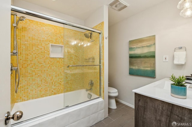 full bathroom with tile patterned floors, toilet, combined bath / shower with glass door, and vanity