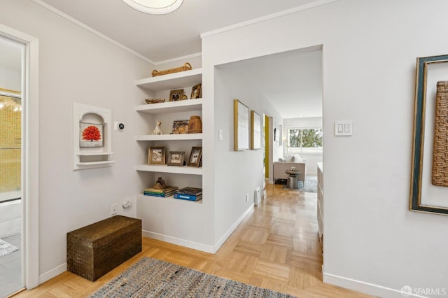 corridor featuring crown molding, built in features, and light parquet floors