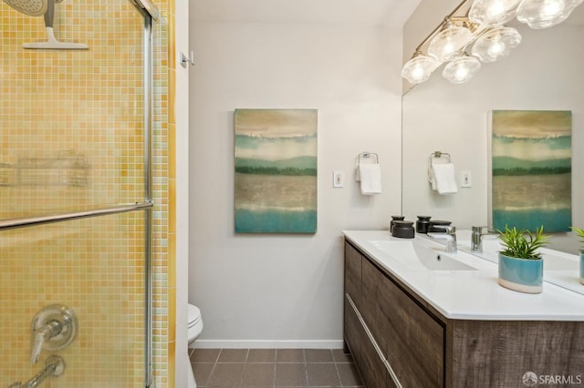 bathroom with tile patterned flooring, vanity, toilet, and walk in shower