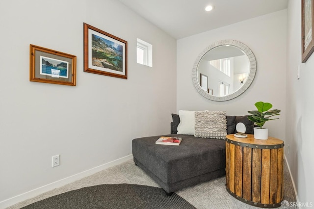 sitting room featuring light colored carpet