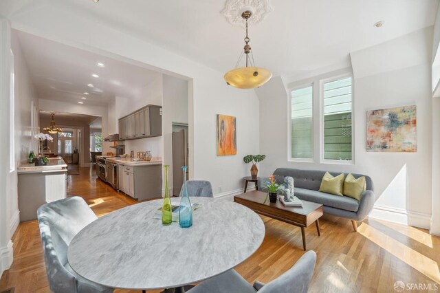 dining room with light wood finished floors, recessed lighting, and baseboards