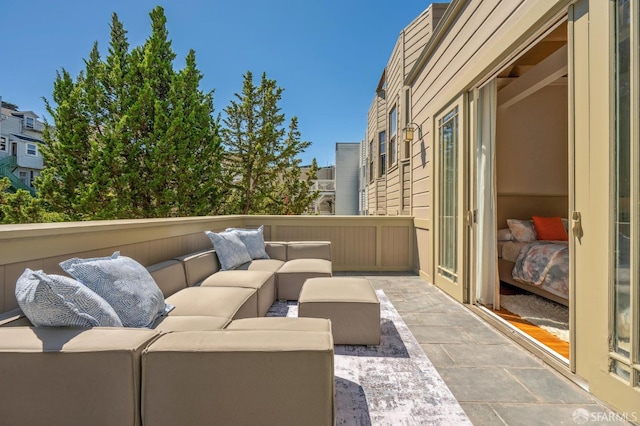 balcony featuring an outdoor living space and a patio area