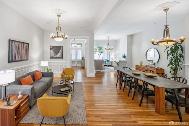 living room featuring a notable chandelier and light wood finished floors