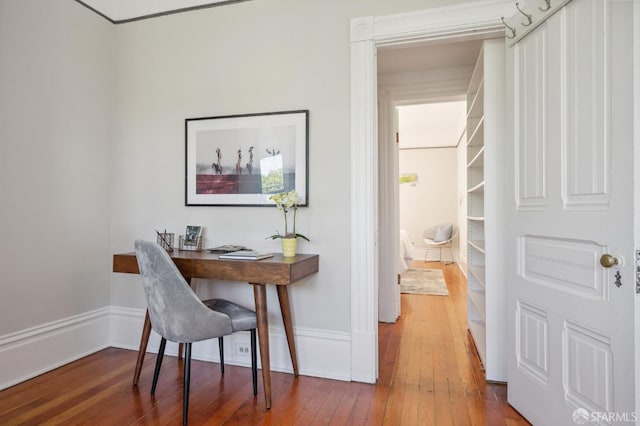 office area featuring baseboards and wood-type flooring