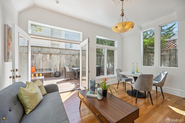 interior space featuring baseboards, lofted ceiling, and wood finished floors