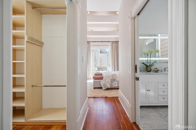 corridor featuring wood finished floors