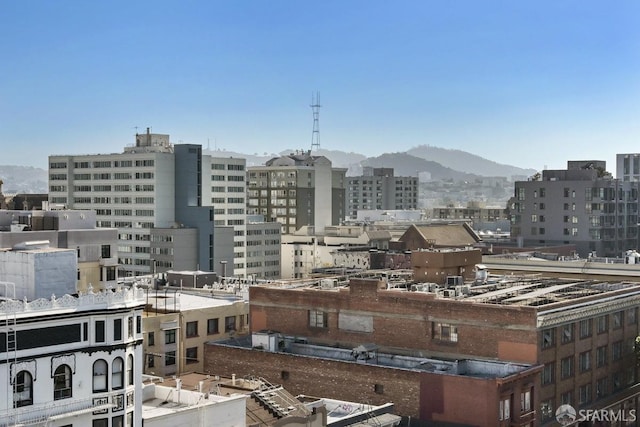 property's view of city with a mountain view