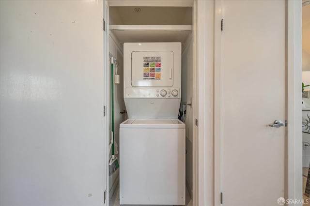 laundry room featuring stacked washing maching and dryer