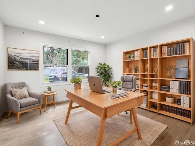 office featuring baseboards, wood finished floors, and recessed lighting