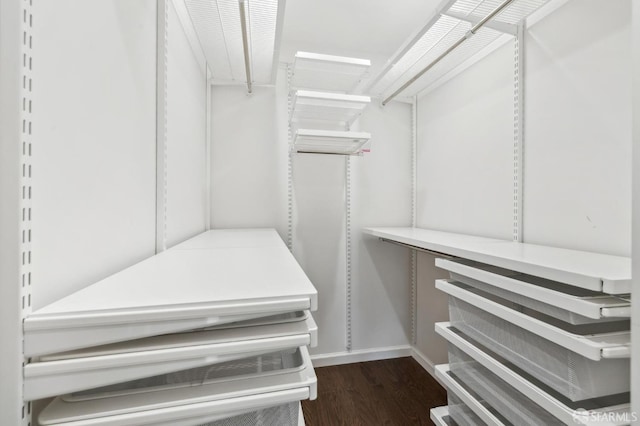 walk in closet featuring dark wood-type flooring