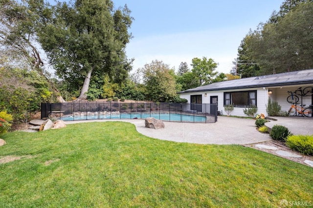 view of yard featuring a patio area, fence, and a fenced in pool