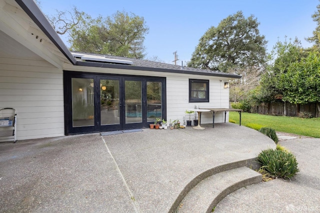 view of patio / terrace featuring fence and french doors