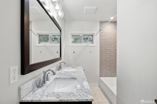 full bathroom with tile patterned flooring, a sink, shower / bathing tub combination, and double vanity