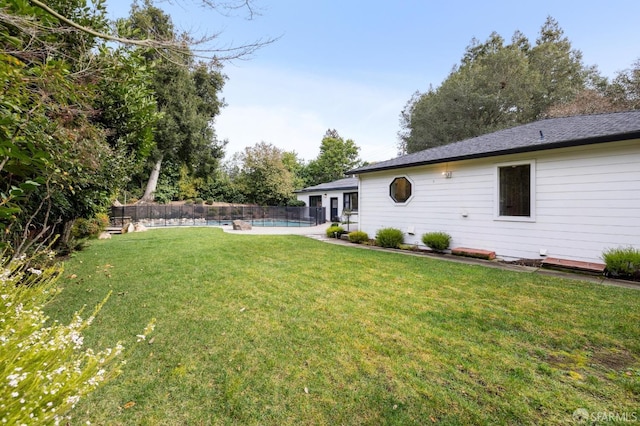 view of yard with fence and a fenced in pool