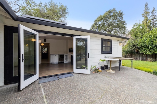 exterior space featuring beverage cooler, a patio area, and fence