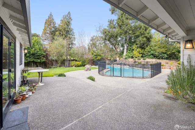 view of pool featuring a patio area, a fenced backyard, and a fenced in pool