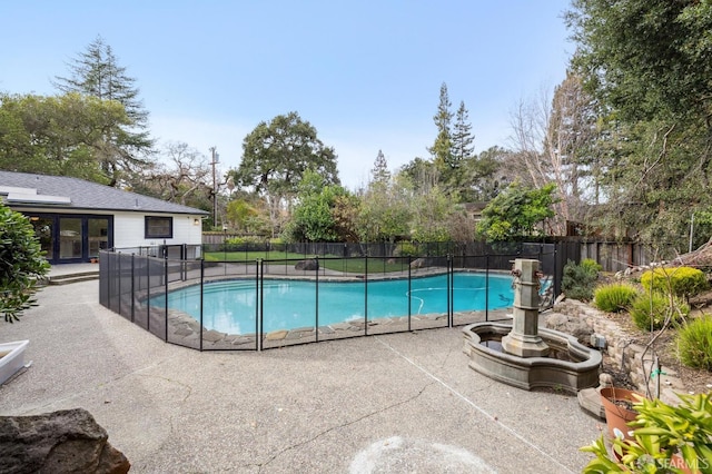 view of swimming pool featuring a fenced in pool, a patio area, and fence