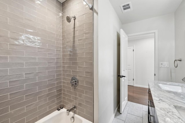 bathroom with baseboards, visible vents, tile patterned flooring, vanity, and washtub / shower combination