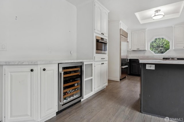 kitchen featuring light countertops, wine cooler, stainless steel appliances, and white cabinets