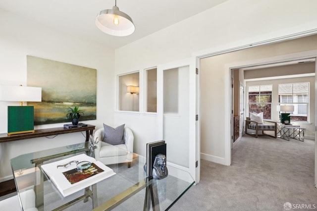 sitting room featuring light colored carpet