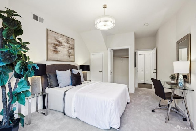 bedroom featuring light carpet and a closet