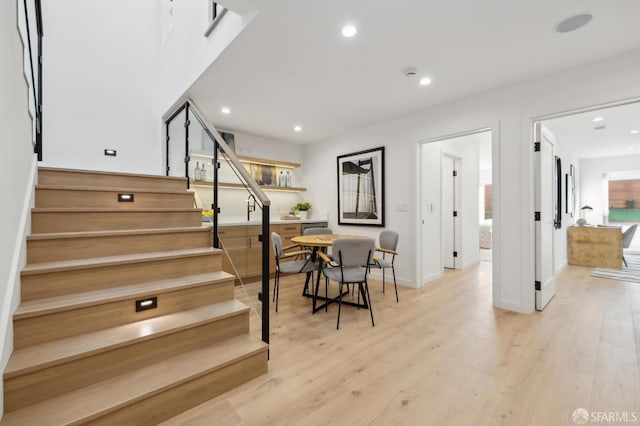 staircase with hardwood / wood-style flooring