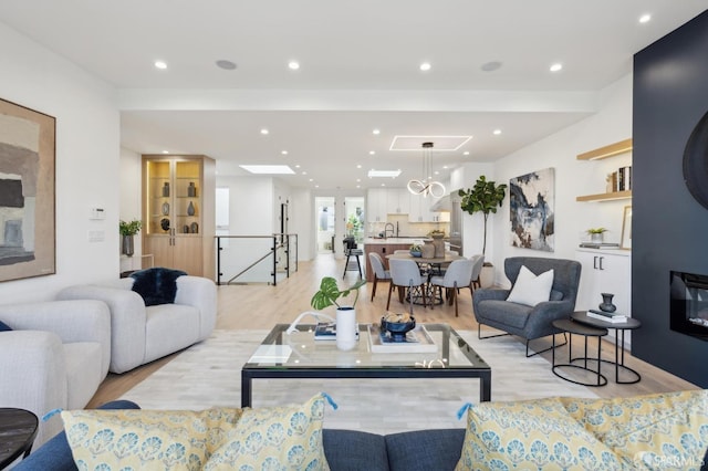 living room featuring sink and light hardwood / wood-style floors