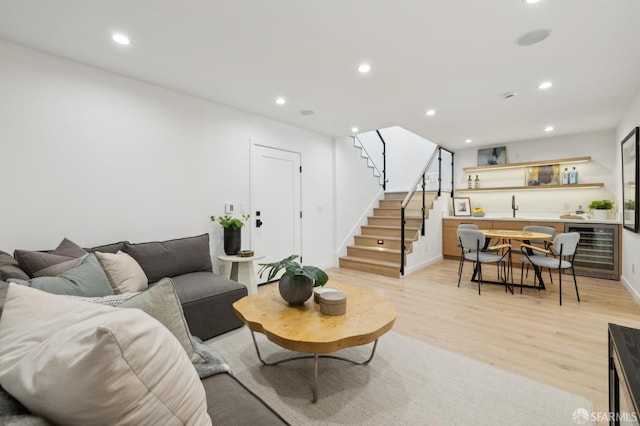 living room with light hardwood / wood-style flooring and wine cooler