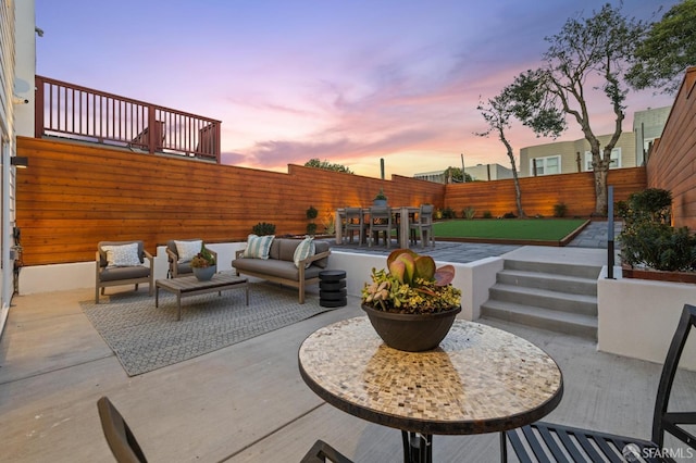 patio terrace at dusk featuring outdoor lounge area