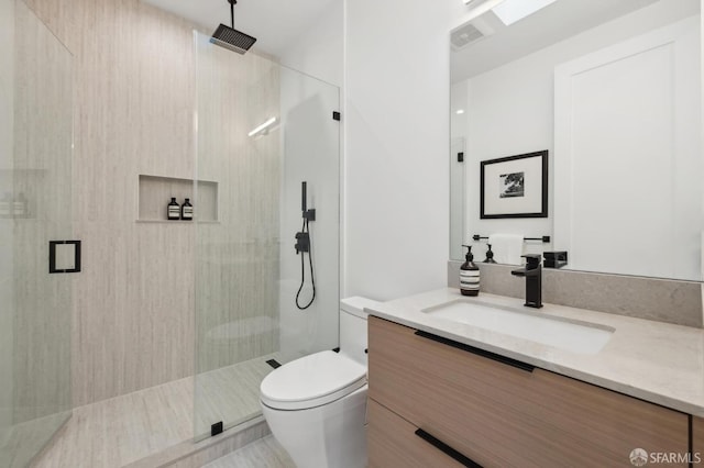 bathroom featuring toilet, an enclosed shower, and vanity