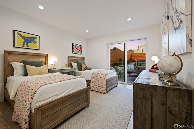 bedroom featuring light wood-type flooring and access to outside