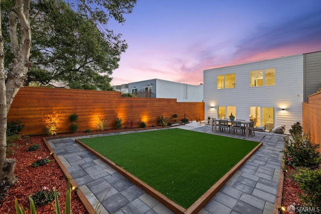 yard at dusk with a patio