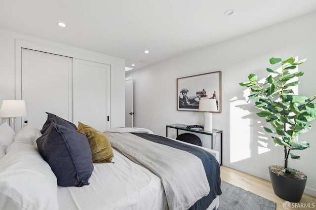 bedroom featuring a closet and light wood-type flooring