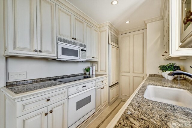 1190 Sacramento St Unit 6, San Francisco, CA 94108 - kitchen with recessed lighting, white appliances, a sink, and light stone counters