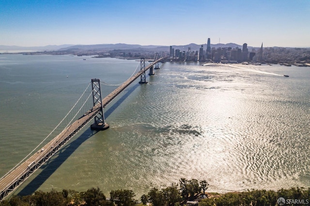 exterior space featuring a water and mountain view and a pier