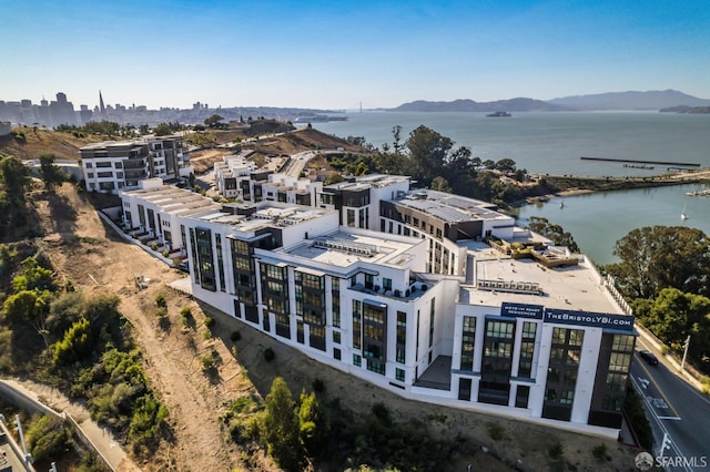 birds eye view of property with a water and mountain view