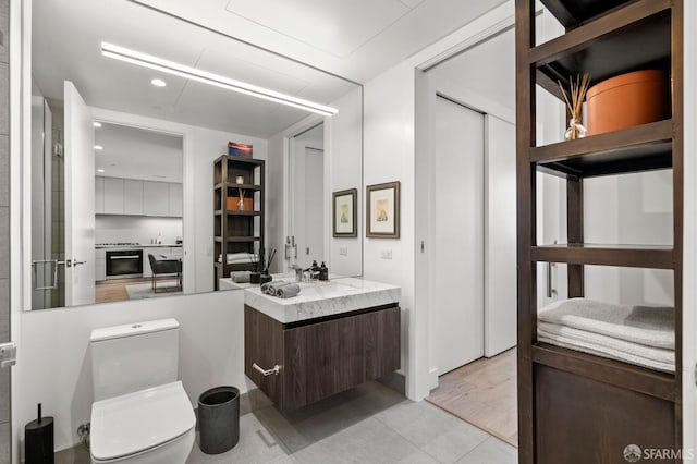 bathroom featuring vanity, recessed lighting, tile patterned flooring, and toilet