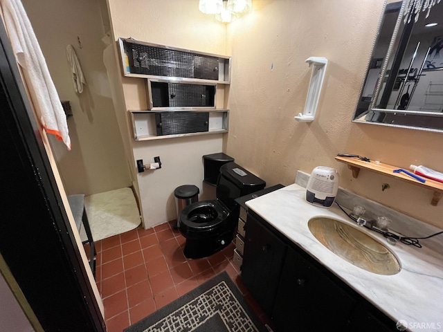 bathroom featuring vanity, tile patterned flooring, and toilet