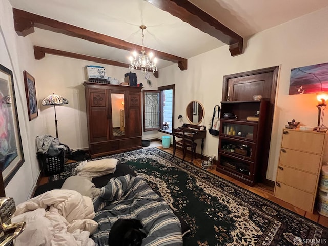 bedroom featuring wood-type flooring, beamed ceiling, and an inviting chandelier